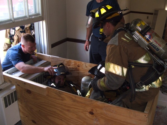 Instructor Kramer teaching us how to remove firefighters from a high rack storage simulator.